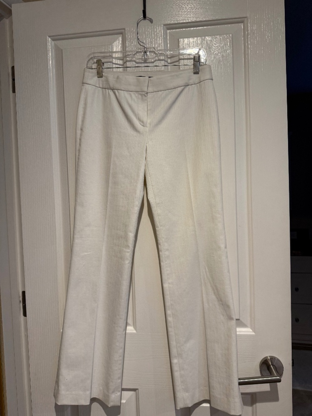 Elie Tahari lined cream color belled low rise pants with pale striped pattern.